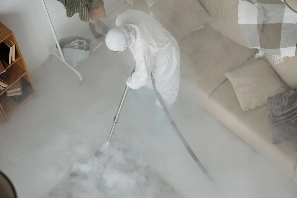 Biohazard cleanup technician in protective equipment, Summit, MS